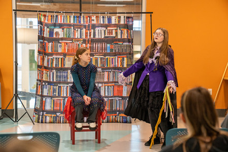 Two young girls performing in front of a group 