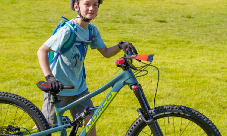 Boy Standing Alongside Bike Posing For Photo