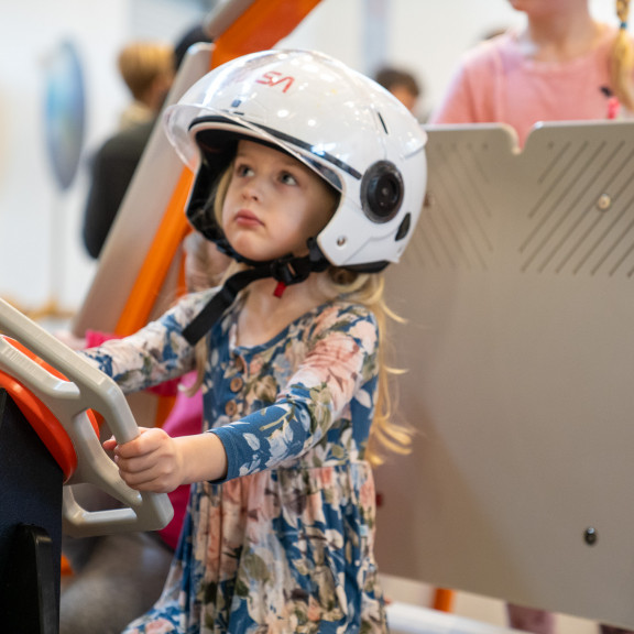 Girl with steering wheel lunar rover