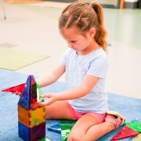 girl playing with magna tiles again